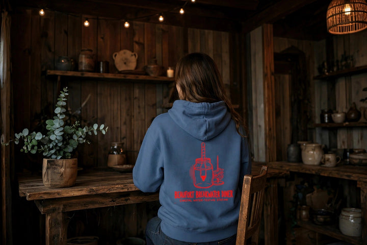 Beaufort Breakwater Diner Hoodie — in the Five Tides room, female back