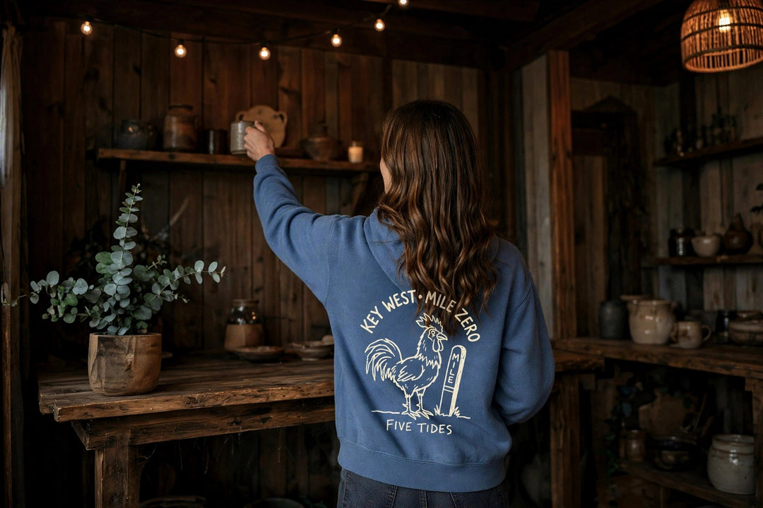 Key West Mile Zero Rooster Hoodie — in the Five Tides room, female back
