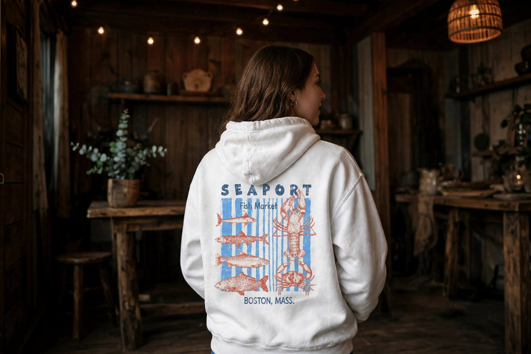 Boston Seaport Fish Market Hoodie — in the Five Tides room, female back