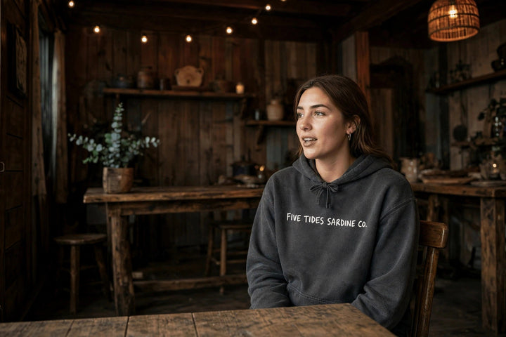 Sardine Co. Logo Hoodie — in the Five Tides room, female front