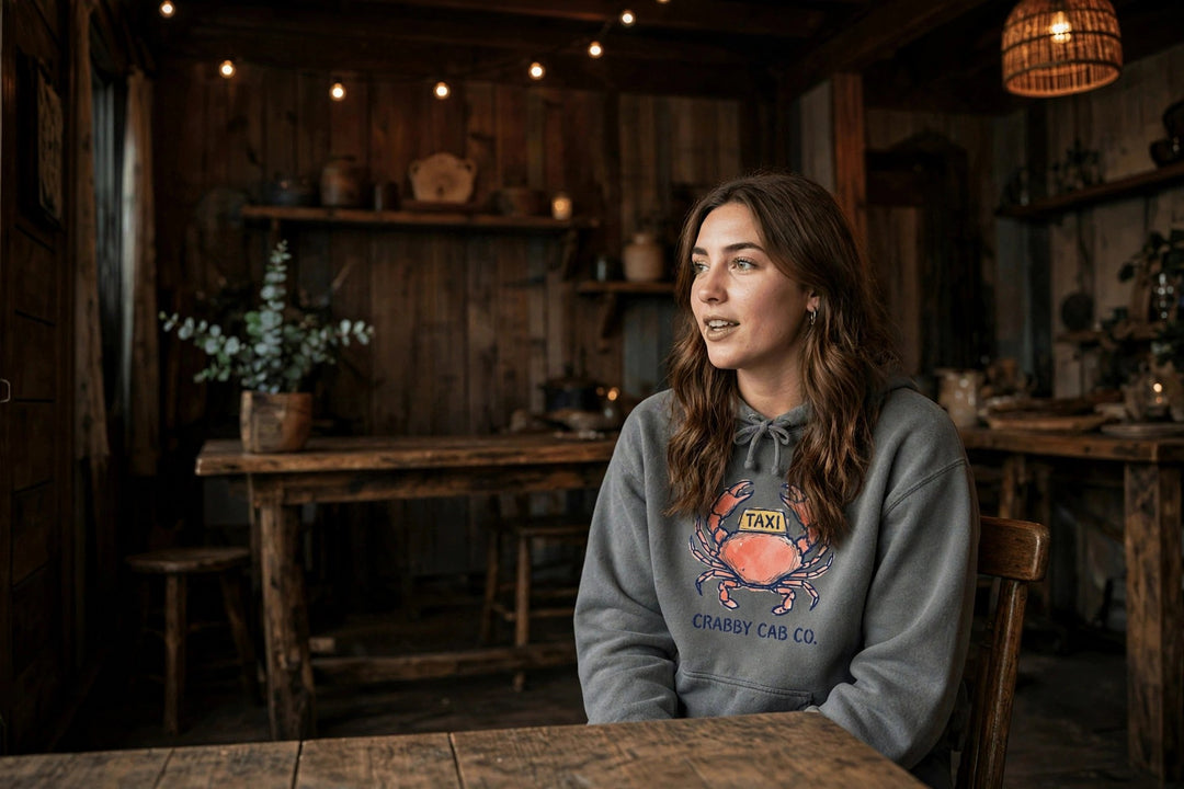 Crabby Cab Co. Crab Taxi Hoodie — in the Five Tides room, female front