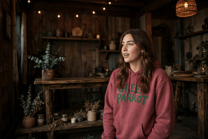 Green Parrot Bar Stool Hoodie — in the Five Tides room, female front