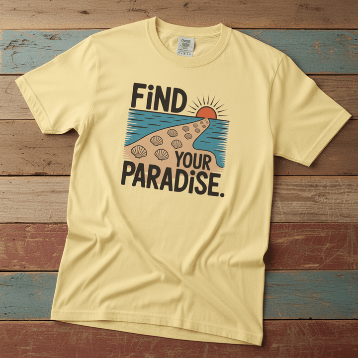 Flat lay - butter yellow Find Your Paradise tee with Comfort Colors label on weathered driftwood planks