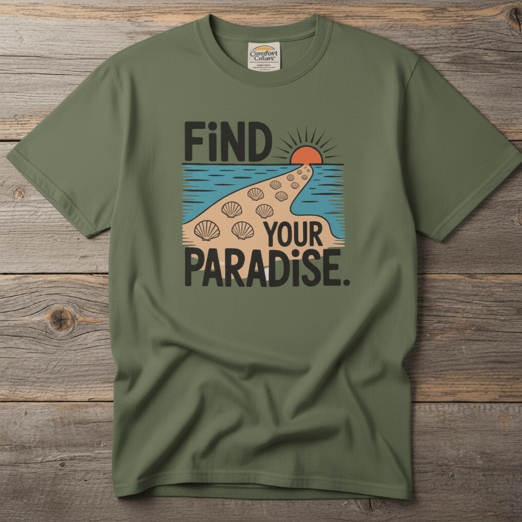 Flat lay - olive green Find Your Paradise tee with Comfort Colors label on weathered driftwood planks