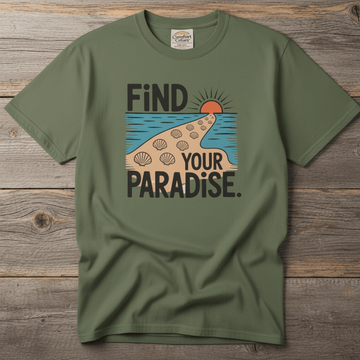 Flat lay - olive green Find Your Paradise tee with Comfort Colors label on weathered driftwood planks