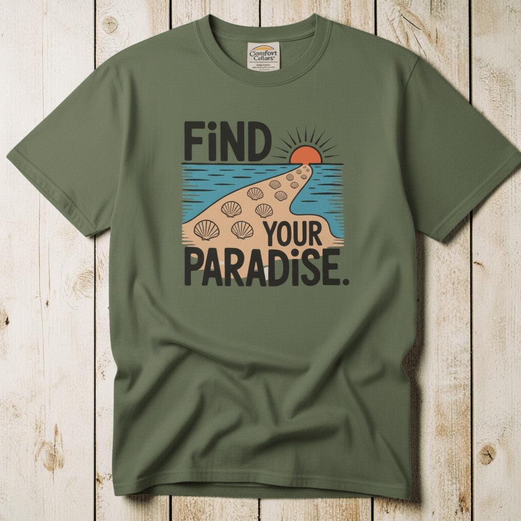 Flat lay - olive green Find Your Paradise tee with Comfort Colors label on weathered driftwood planks