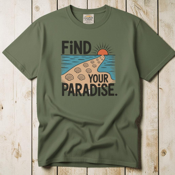 Flat lay - olive green Find Your Paradise tee with Comfort Colors label on weathered driftwood planks
