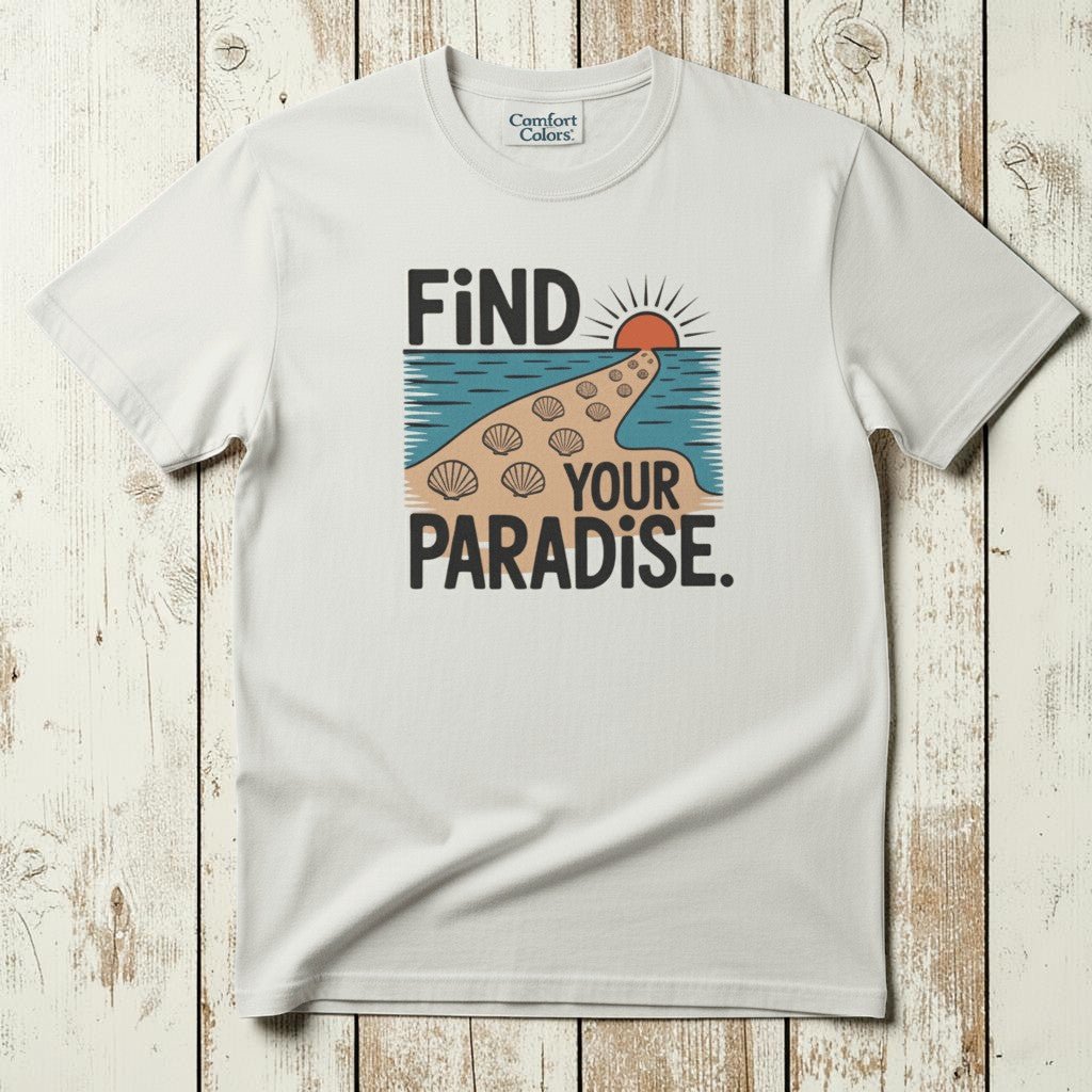 Flat lay - white Find Your Paradise tee with Comfort Colors label on weathered driftwood planks
