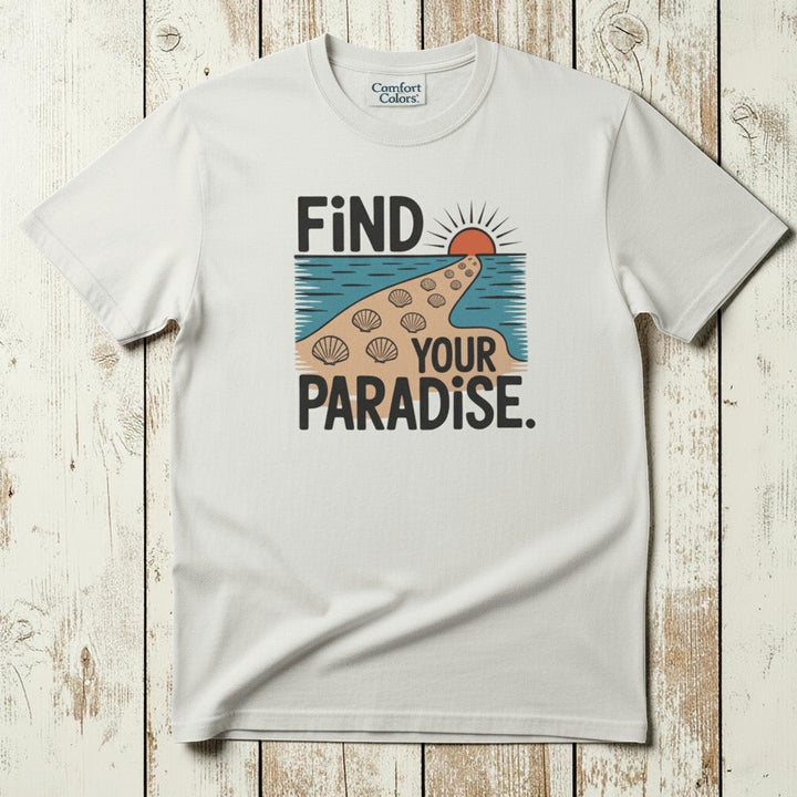 Flat lay - white Find Your Paradise tee with Comfort Colors label on weathered driftwood planks