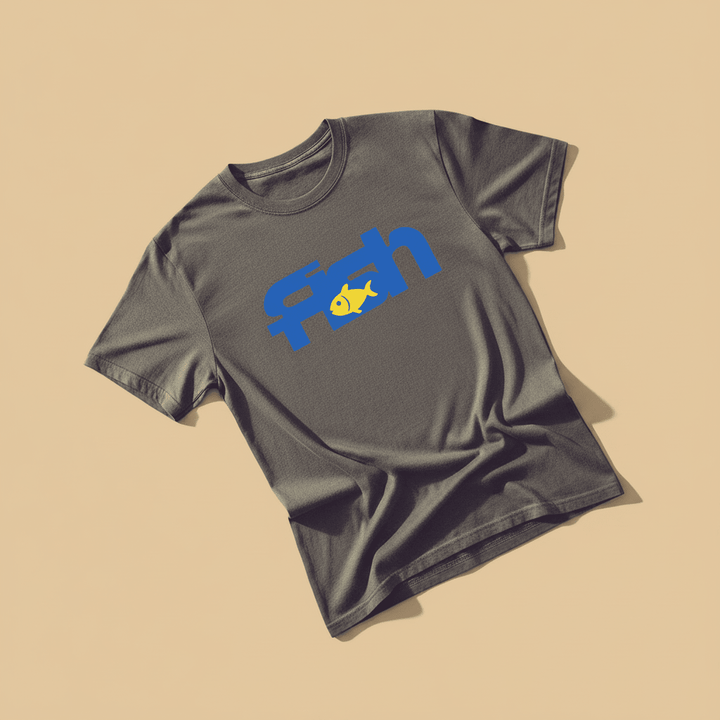 Fish Tee in Graphite — front graphic, warm sand studio background