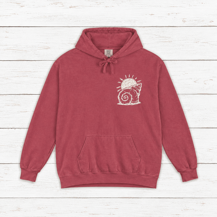 Beach Snail hoodie flat lay on whitewashed boards