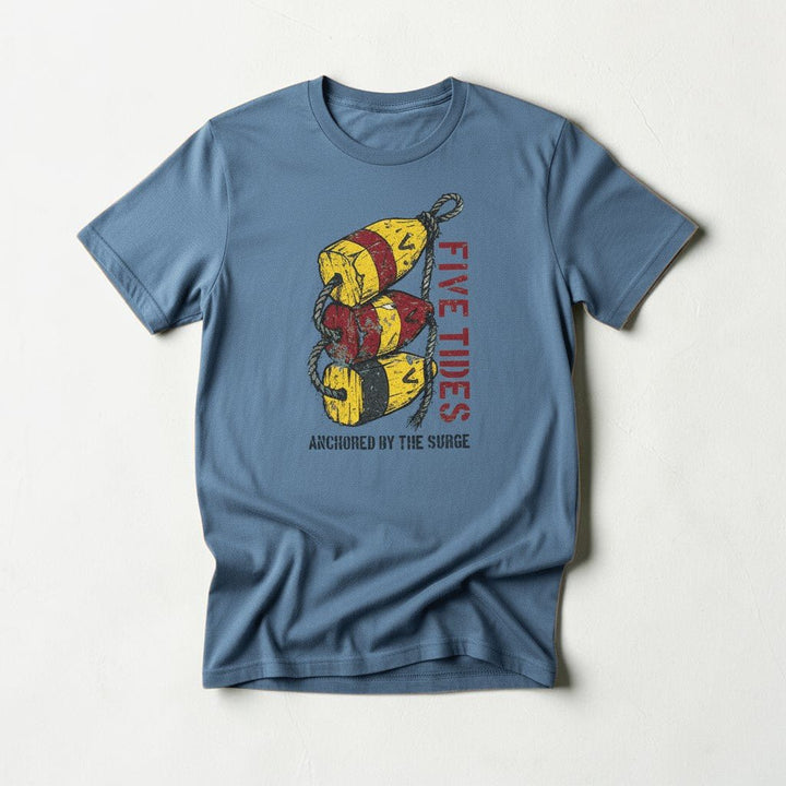 Flat lay - slate blue Five Tides Anchored by the Surge tee on weathered driftwood planks
