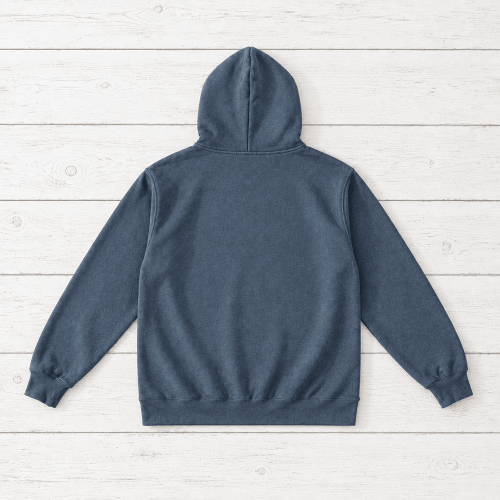 Nomad Coastal Adventure denim hoodie close-up of graphic — bold wordmark graphic pullover by Five Tides Apparel