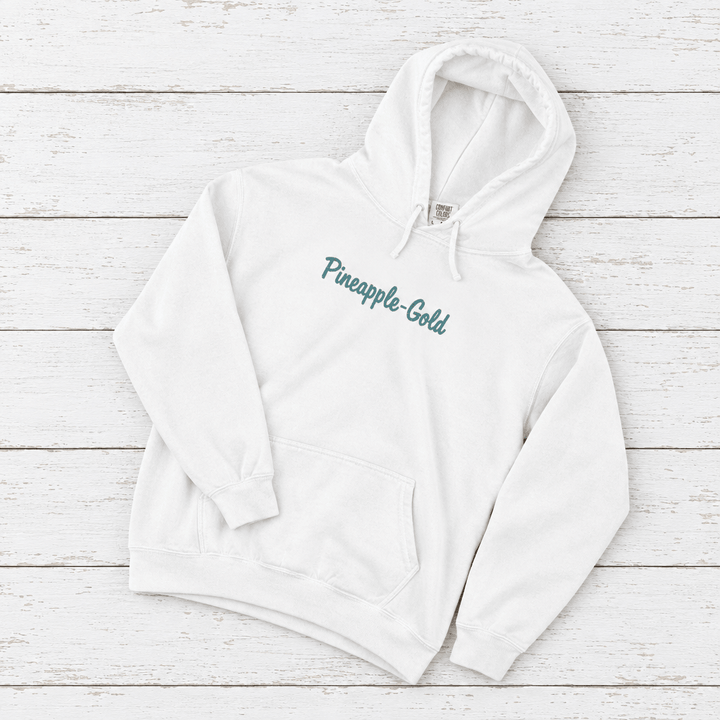 Pineapple-Gold rooster hoodie flat lay on whitewashed boards