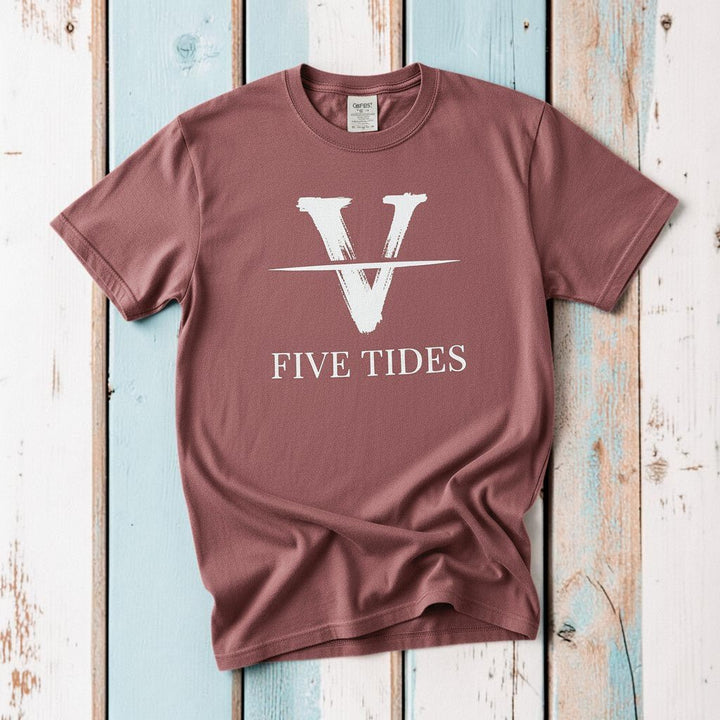 Flat lay - mauve Five Tides V tee with Comfort Colors label on weathered driftwood planks