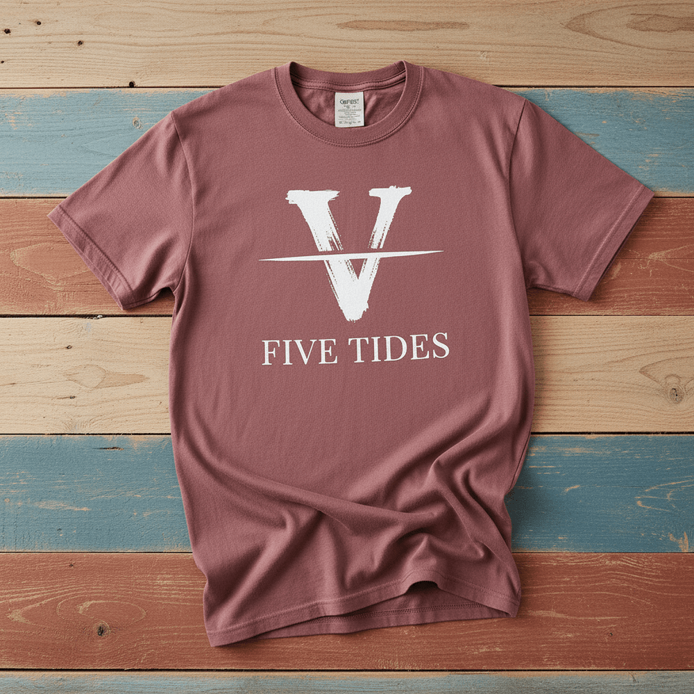 Flat lay - mauve Five Tides V tee with Comfort Colors label on weathered driftwood planks