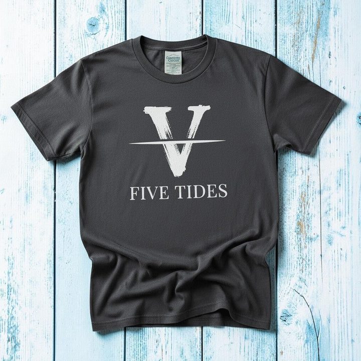 Flat lay - charcoal Five Tides V tee with Comfort Colors label on weathered driftwood planks