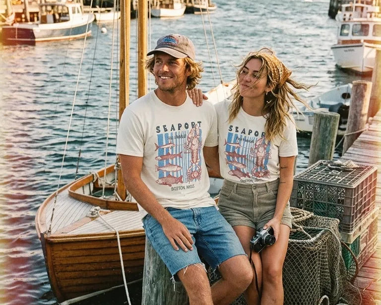 Two people sitting on a dock by a boat with a scenic background