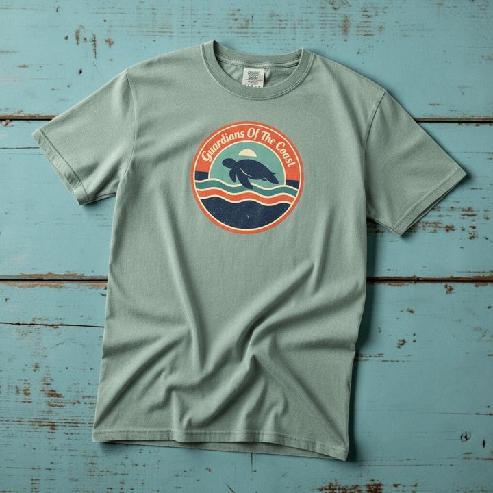 Guardians of the Coast Turtle Retro Badge bay garment-dyed tee on faded driftwood planks