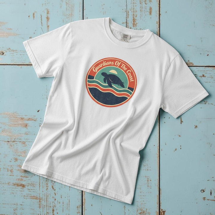 Guardians of the Coast Turtle Retro Badge white garment-dyed tee on faded driftwood planks