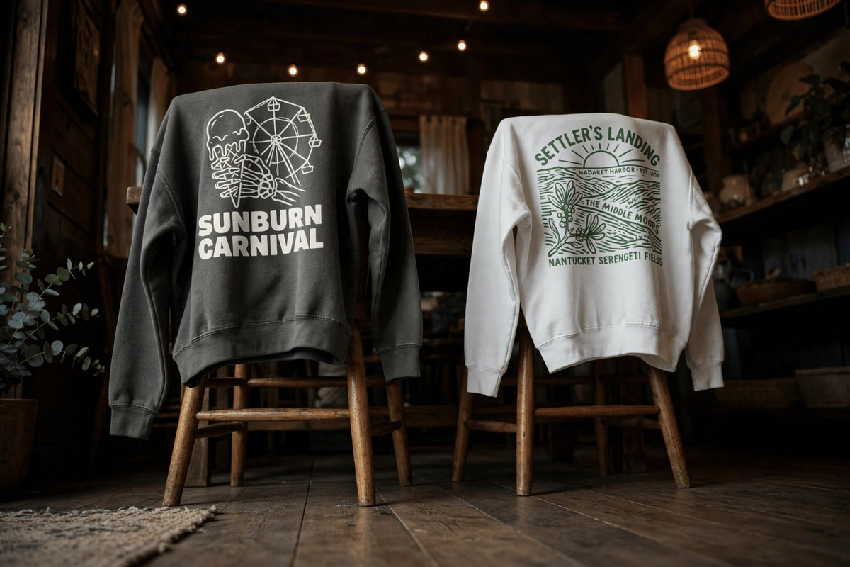 Five Tides garment-dyed sweatshirts draped over chairs in a dim rustic room