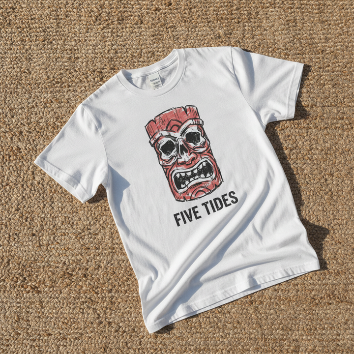 Red Tiki Skull FIVE TIDES surf graphic t-shirt in White casually tossed on a light sand-colored woven rug, coastal lifestyle product photo