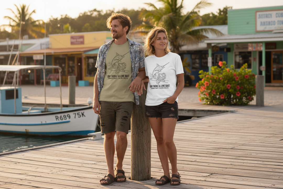 Couple wearing khaki and white OBX Tackle &amp; Live Bait tees on tropical island dock