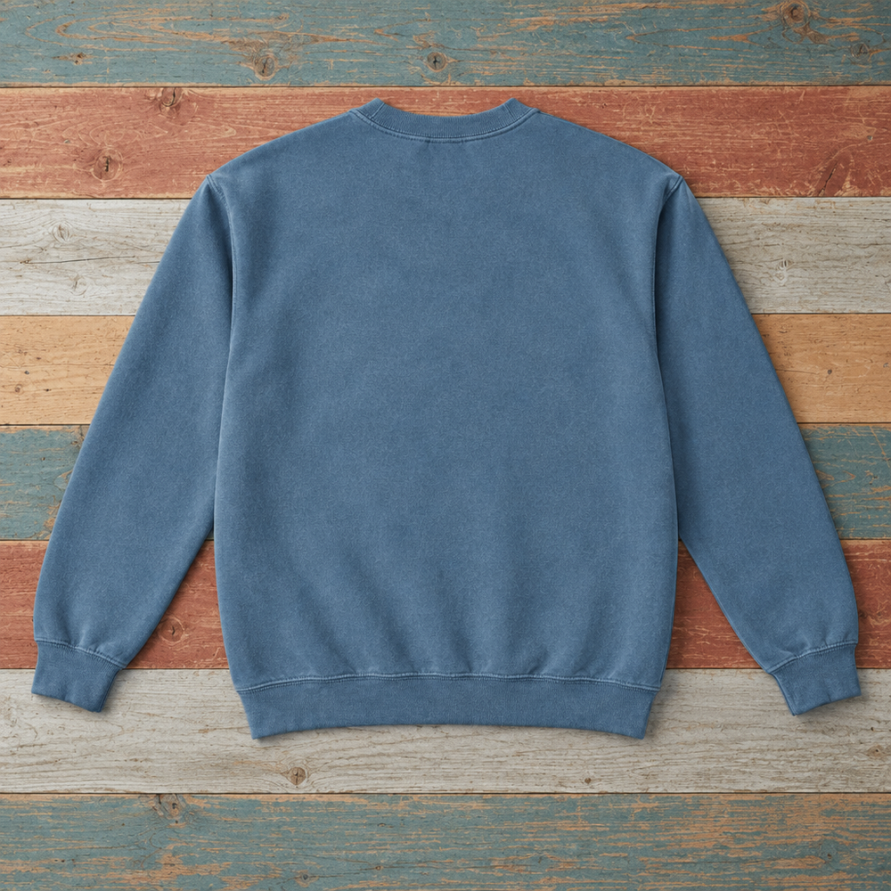 Plain back of Bar Harbor crewneck sweatshirt in Blue Jean on colorful weathered driftwood boards