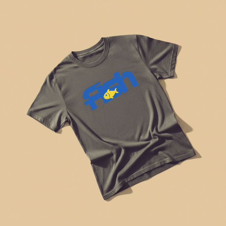 Fish Tee in Graphite — front graphic, warm sand studio background