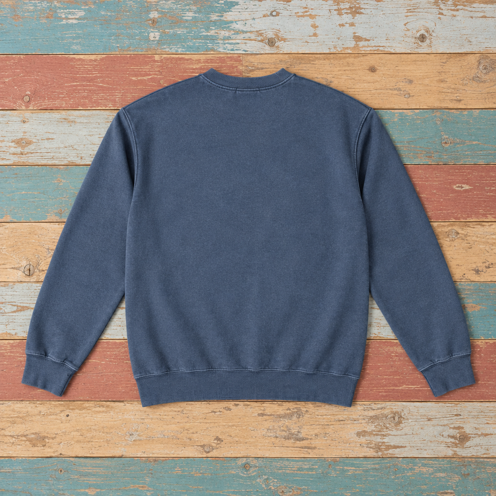 Plain back of Montauk crewneck sweatshirt in Denim on colorful weathered driftwood boards