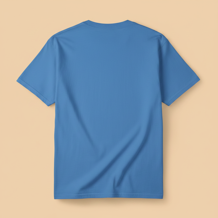 Saltwater Surf Club Tee in Bay Blue — plain back, warm sand studio background