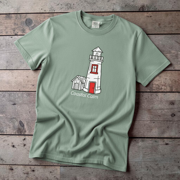 Lighthouse Coastal Calm light green garment-dyed tee on faded driftwood planks