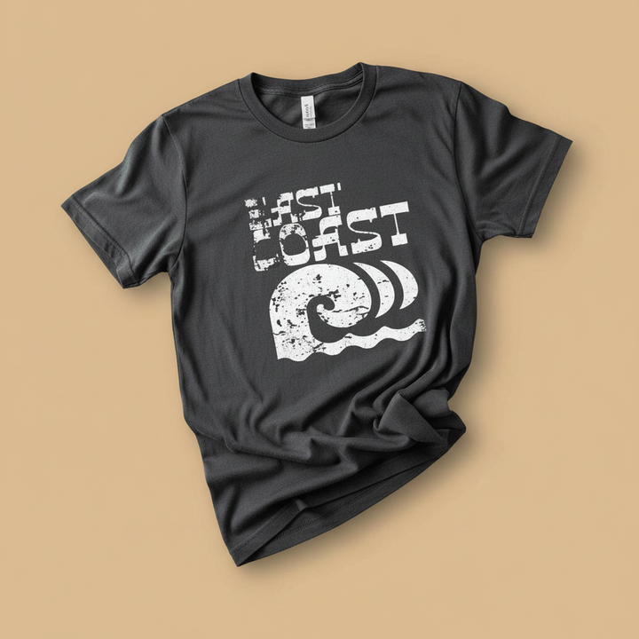 East Coast Tee in Pepper/Charcoal — front graphic, warm sand studio background