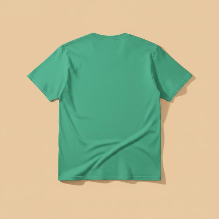 Norfolk Island Tee in Green — plain back, warm sand studio background