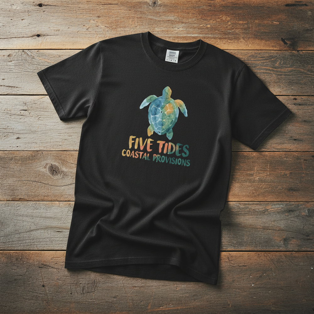 Sea Turtle Coastal black garment-dyed tee casually tousled on rustic reclaimed wood