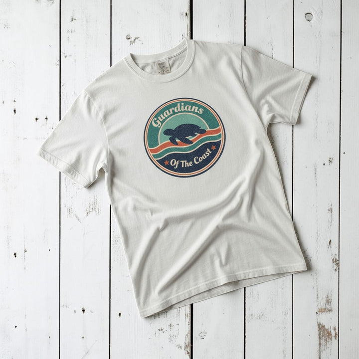 Sea Turtle Guardians of the Coast white garment-dyed tee on faded driftwood planks