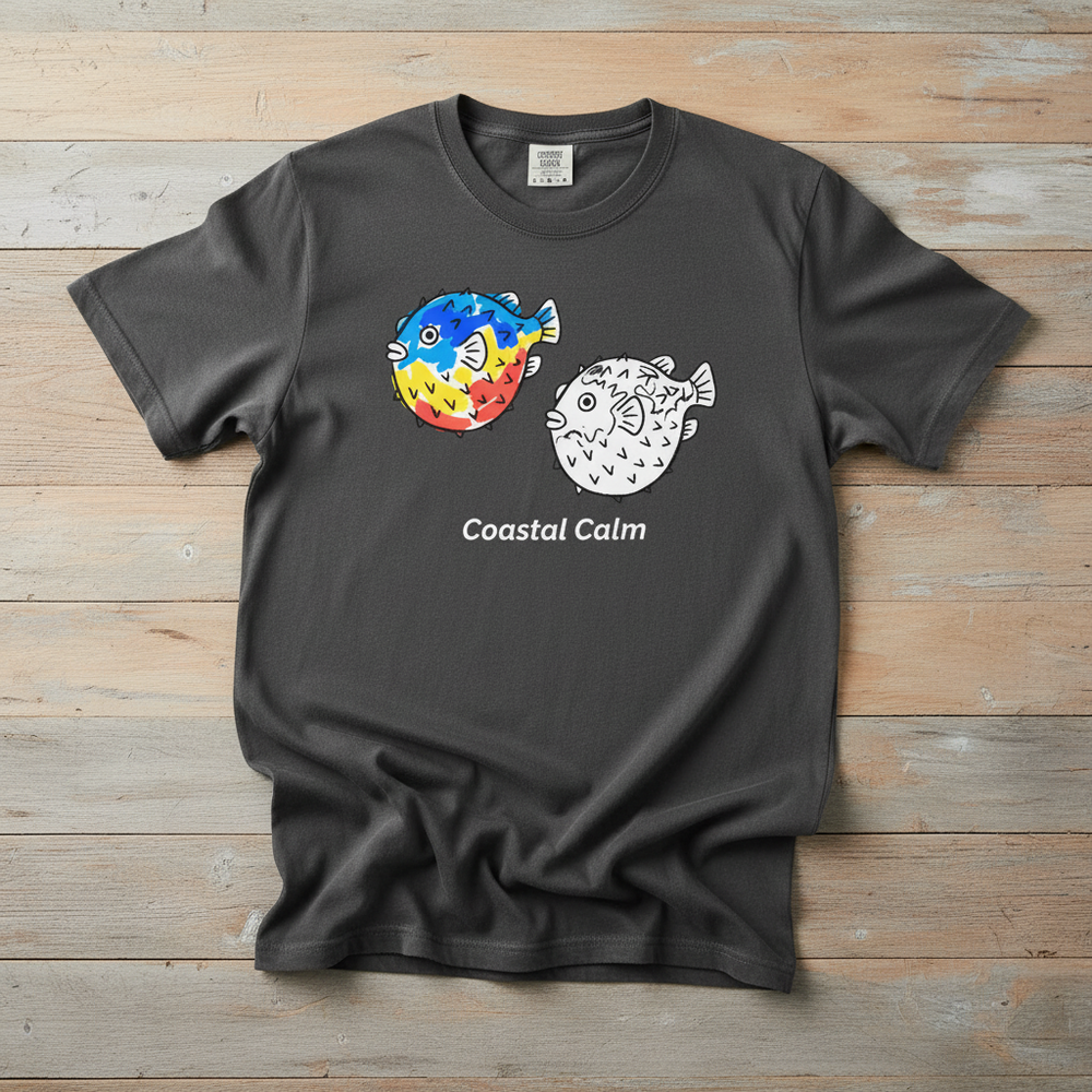 Puffer Fish Coastal Calm graphite garment-dyed tee on faded driftwood planks