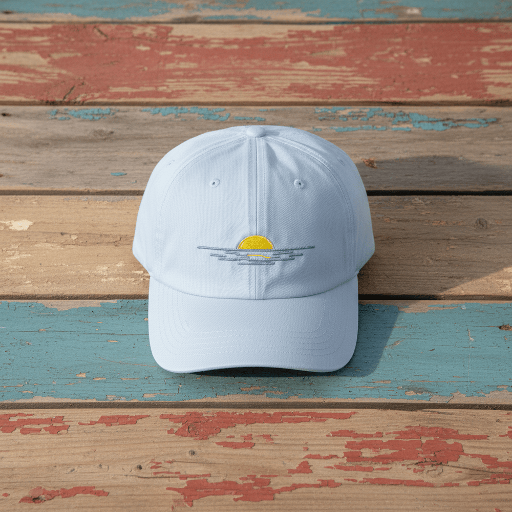 Sunrise Minimal Beach Embroidered Cap light blue on faded driftwood planks