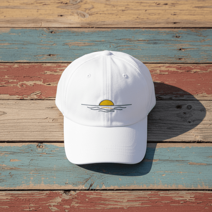 Sunrise Minimal Beach Embroidered Cap white on faded driftwood planks