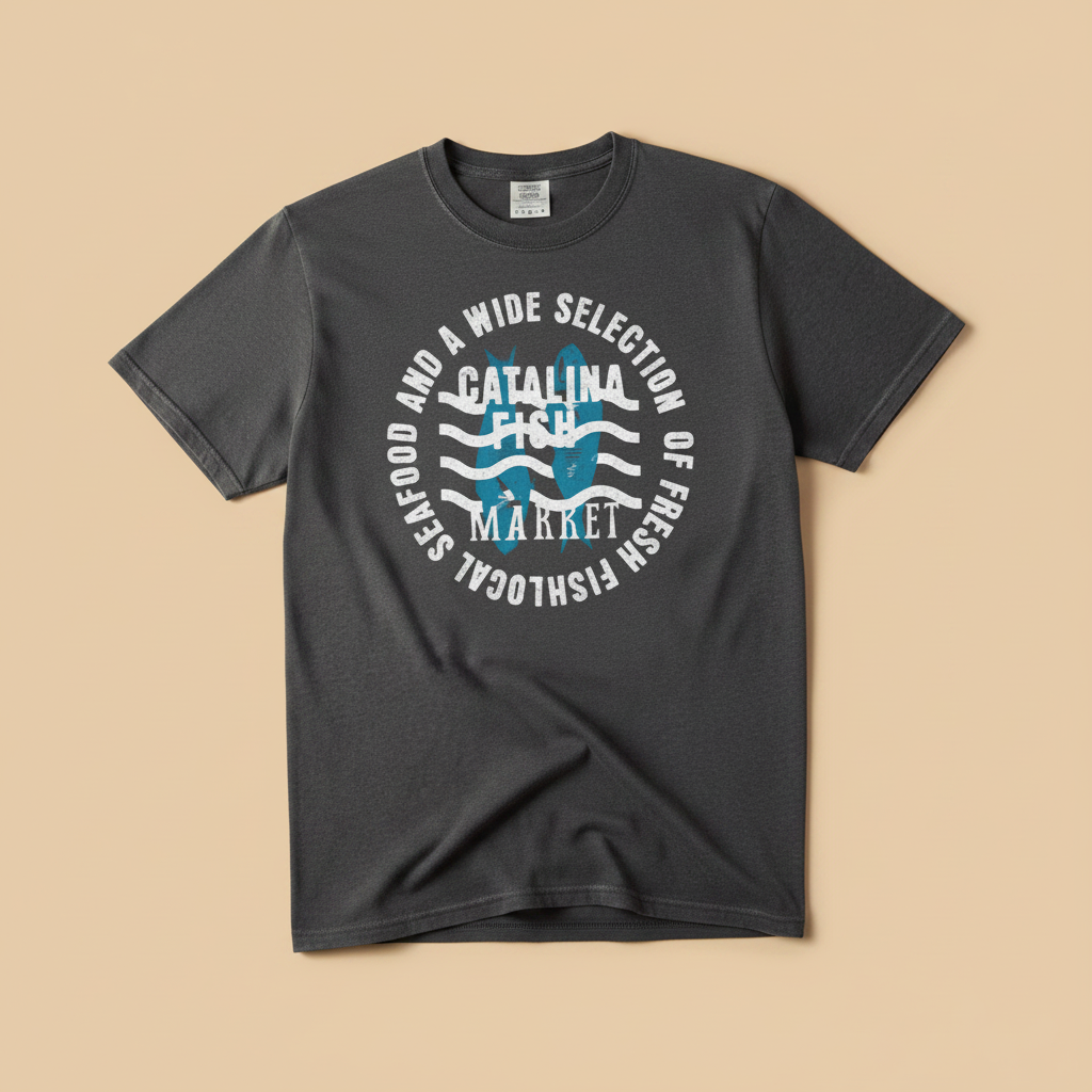 Catalina Fish Market Tee in Pepper/Charcoal — front graphic, warm sand studio background