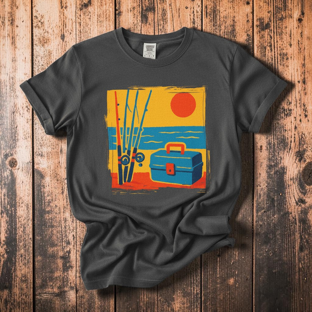 Vintage Tackle Box Sunset graphite garment-dyed tee on faded driftwood planks