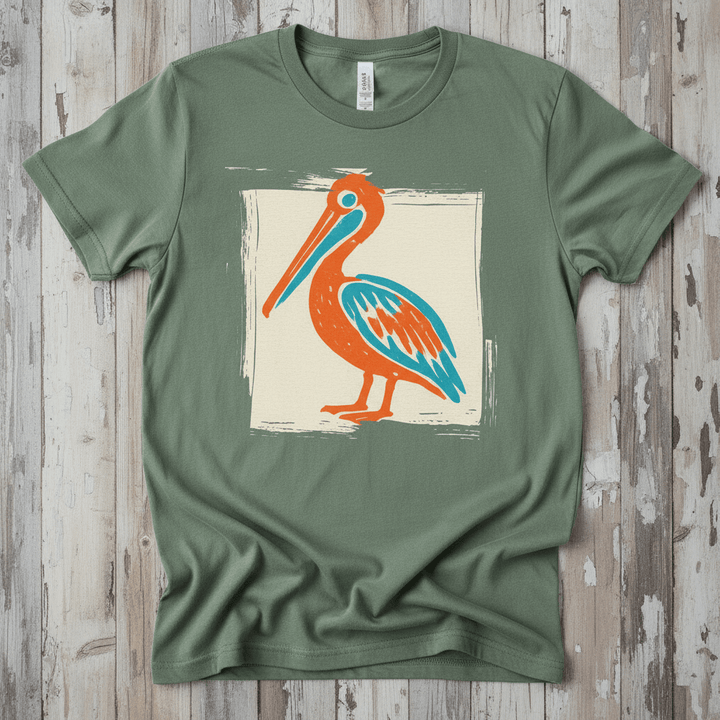 Colorful Beach Pelican sage garment-dyed tee on faded driftwood planks