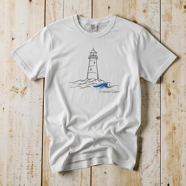 Coastal Calm Lighthouse Blue Sea white garment-dyed tee on faded driftwood planks