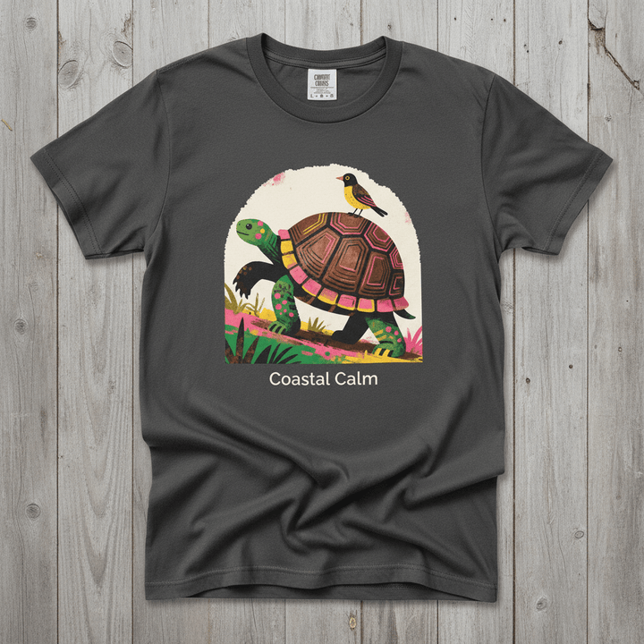 Coastal Calm Turtle Climbing Buddies graphite garment-dyed tee on faded driftwood planks