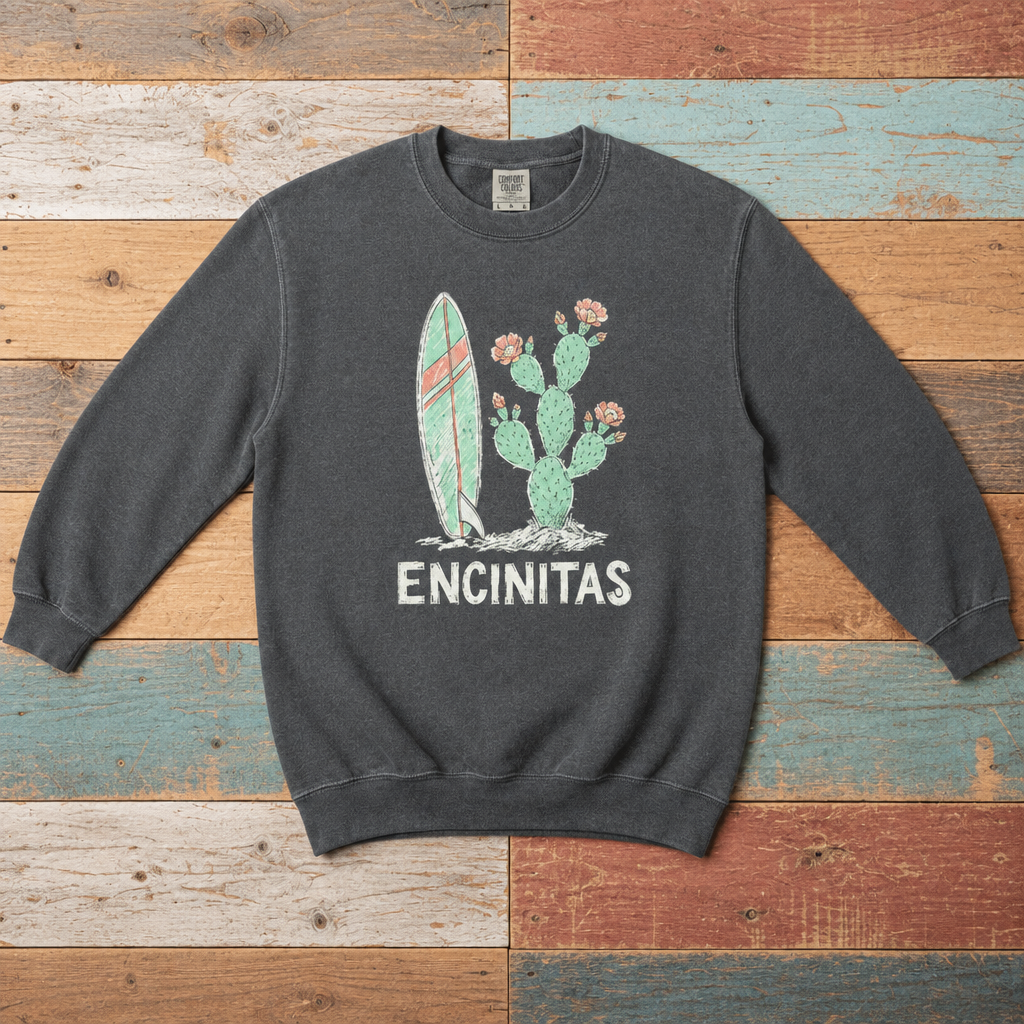 Pepper Encinitas sweatshirt front with surfboard, flowering cactus, and ENCINITAS graphic on driftwood boards