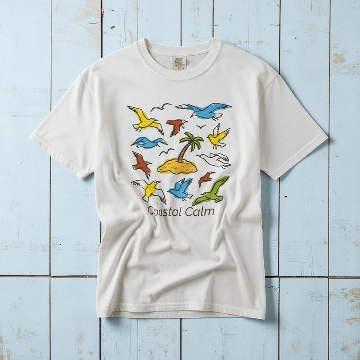 Coastal Calm Sea Birds Take Flight white garment-dyed tee on faded driftwood planks