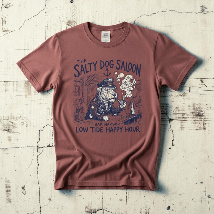 Salty Dog Saloon nautical bar sea captain graphic t-shirt in Brick casually tossed on a light sand-colored woven rug, coastal lifestyle product photo