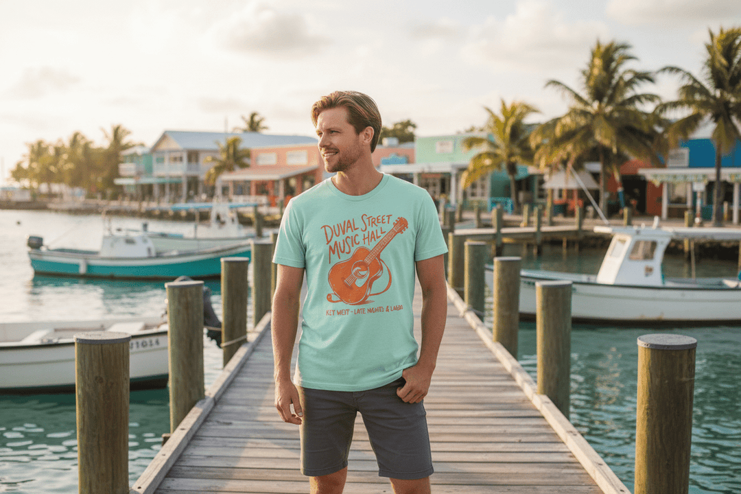 Couple wearing natural and mint Duval Street Music Hall t-shirts on tropical island beach town boat dock