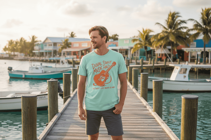 Couple wearing natural and mint Duval Street Music Hall t-shirts on tropical island beach town boat dock