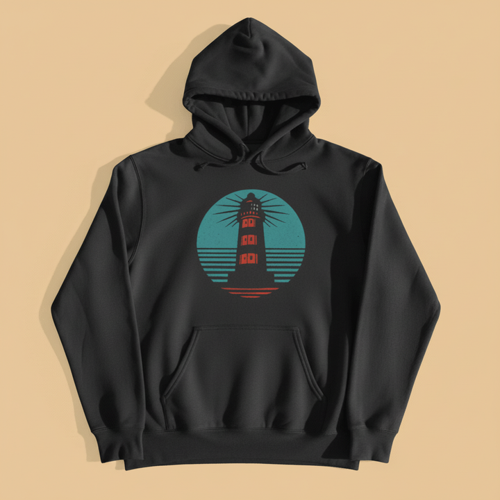 Coastal Lighthouse Hoodie in Pepper — front graphic, warm sand studio background